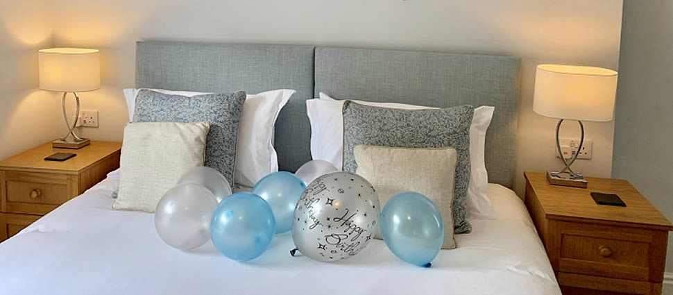 Room Extras such as balloons and banners to celebrate a special occasion, by arrangement